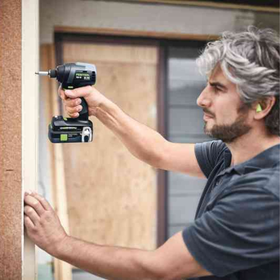 Man using Festool TID 18 cordless impact screwdriver on a wall frame