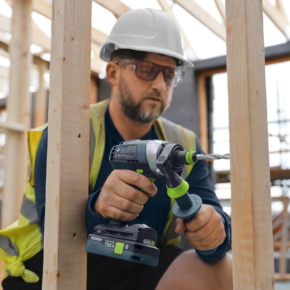 Man using Festool drill with Festool Tabless Battery on wood frame 