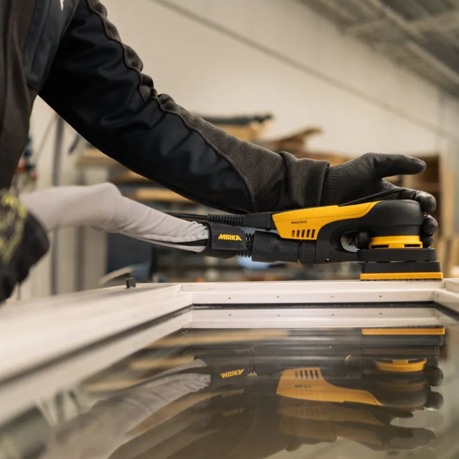 Person using Mirka DEOS II 3x4 Inch Orbital Sander  on a window frame