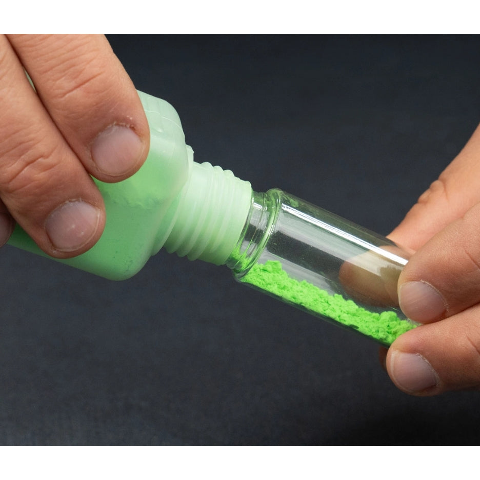 Hands holding Pica Powder Refill pack and using it to refill Pica Powder Marker