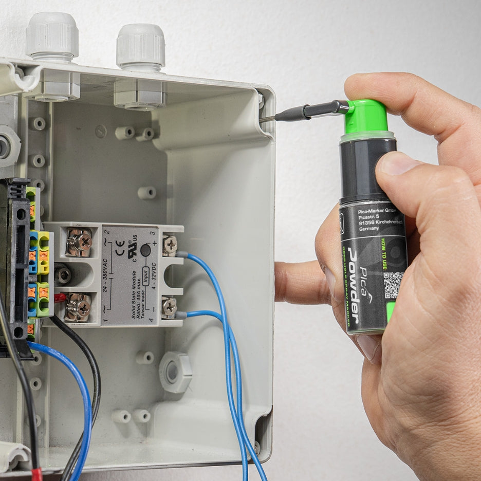 Pica Powder Marker being used to mark a hole in an electrical box
