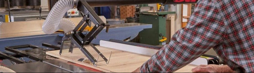 Man cutting piece of wood sing SawStop Industrial Cabinet Table Saw 