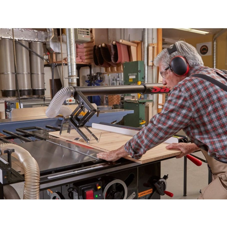 Man cutting piece of wood sing SawStop Industrial Cabinet Table Saw 