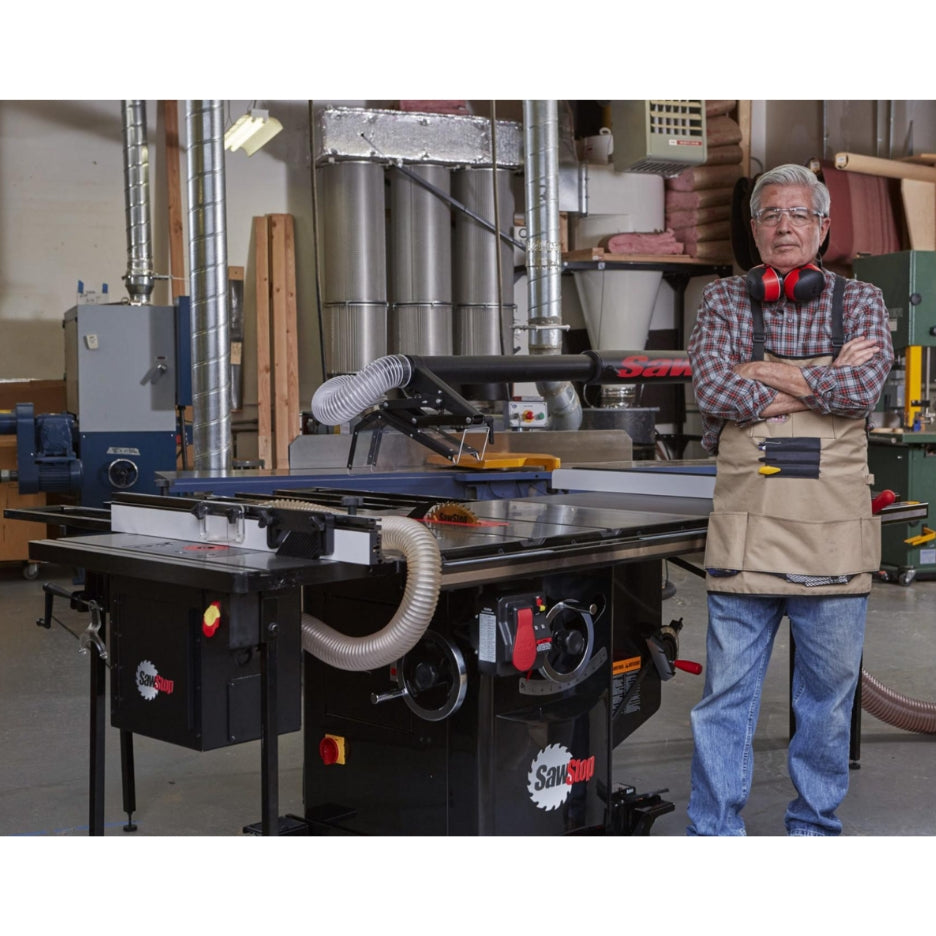 Man with arms crossed standing next to SawStop Industrial Cabinet Table Saw