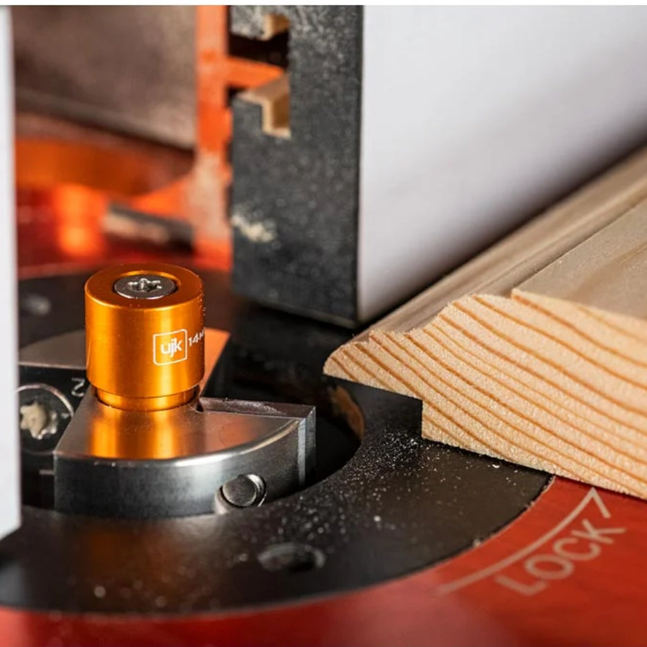 Close-up of a router with UJK Tools 2-Flute Metric Multi-Rabbetting Router Bit with 1/2 Inch Shank and wooden piece being cut.