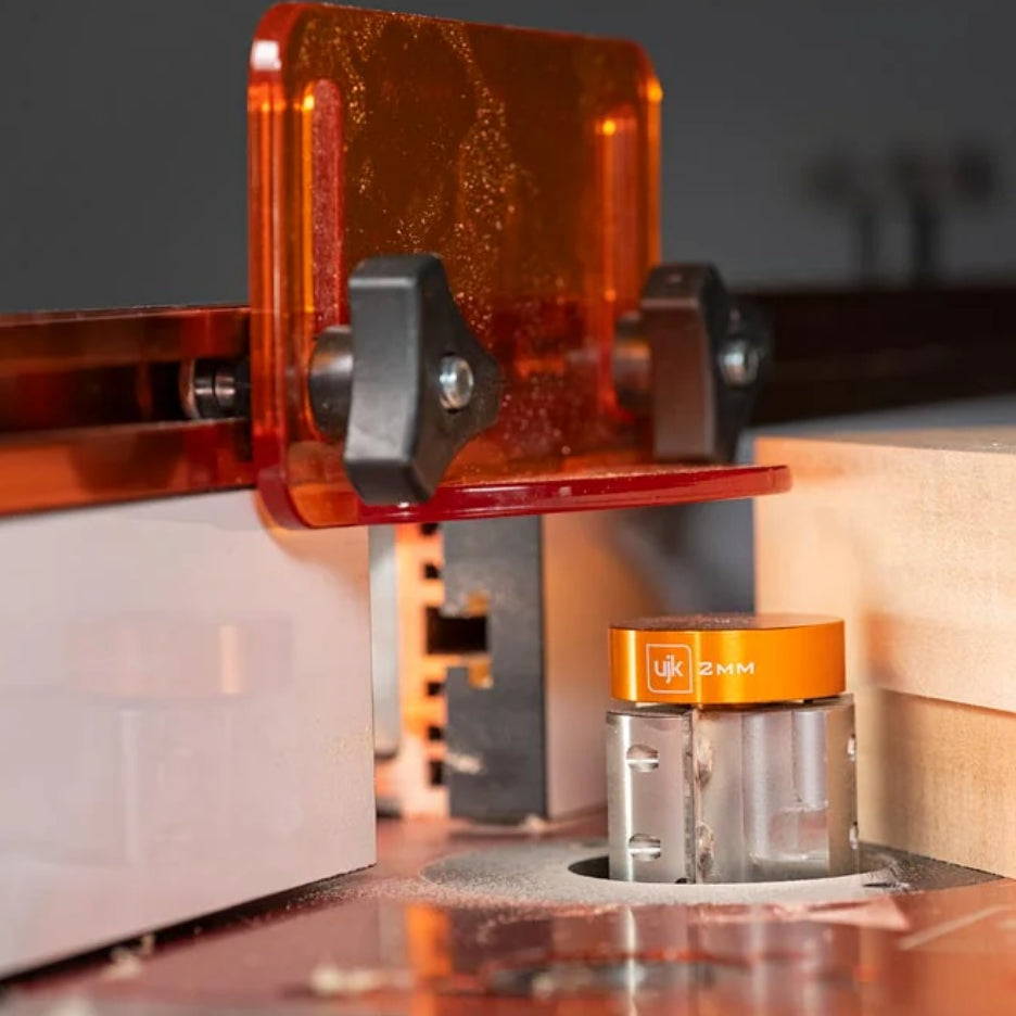 Close-up of UJK Tools 3-Flute Metric Multi-Rabbetting Router Bit with 1/2 Inch Shank in a router table