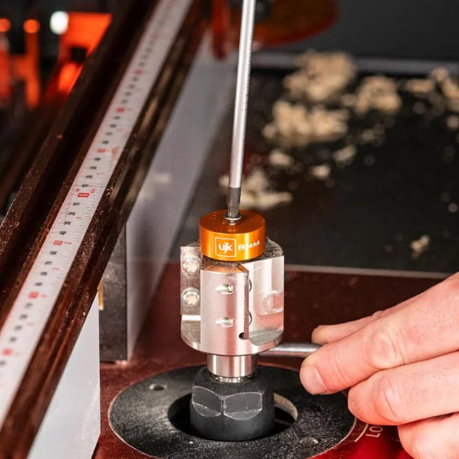 Close-up of person adjusting UJK Tools 3-Flute Metric Multi-Rabbetting Router Bit with 1/2 Inch Shank 
