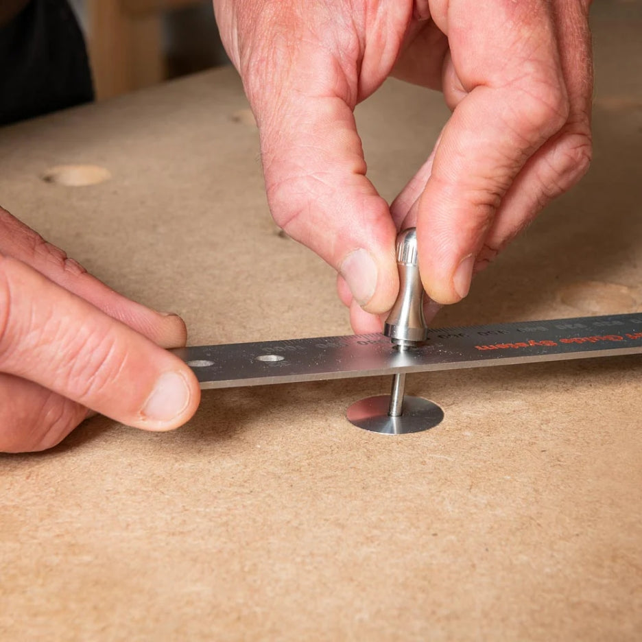 Metal pin being inserted in UJK Parf dog in MFT table 