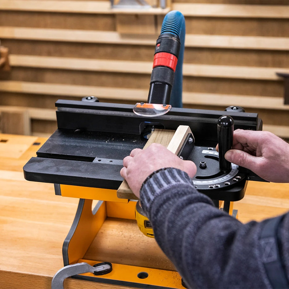 Person usingUJK Tools Portable Trim Router Table on a wooden workbench