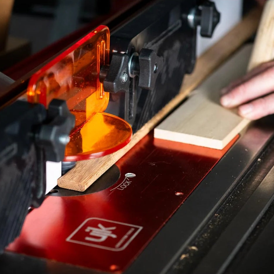 Router with UJK Tools Router Bit for with a piece of wood being cut.