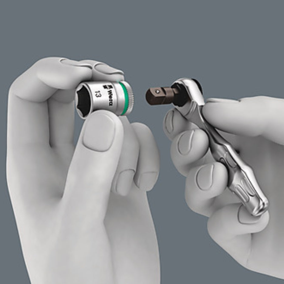 Hands holding mini ratchet and socket