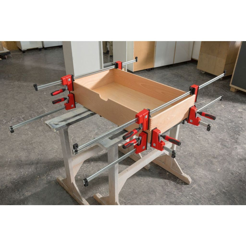 Slide the fixed head of the Bessey K Body VARIO REVOlution 1700 Pound Parallel Bar Clamp to make the clamp more balanced over the workpiece and easier to maneouver