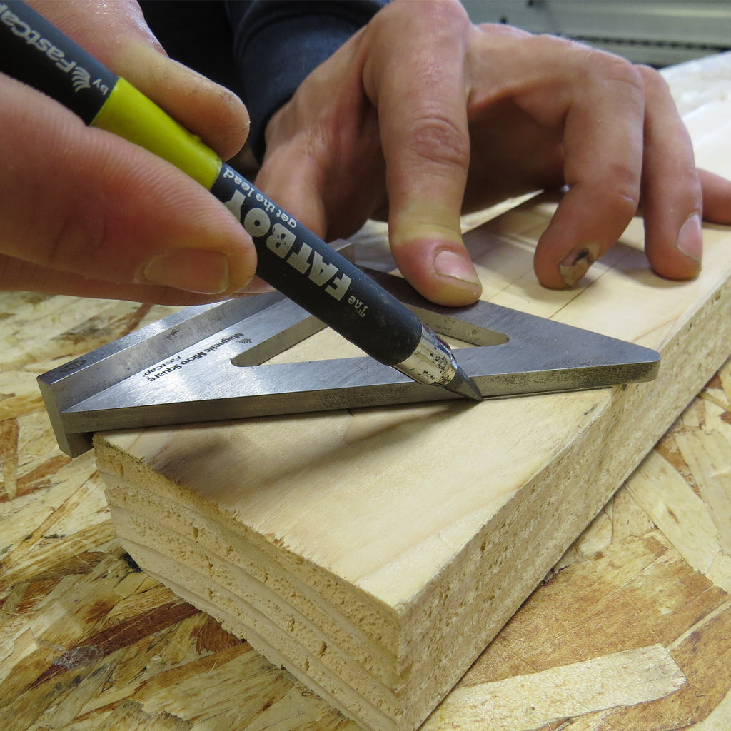 The wide base provides a reliable reference edge when performing layout tasks, such as marking this 2x4 for a mitre cut.