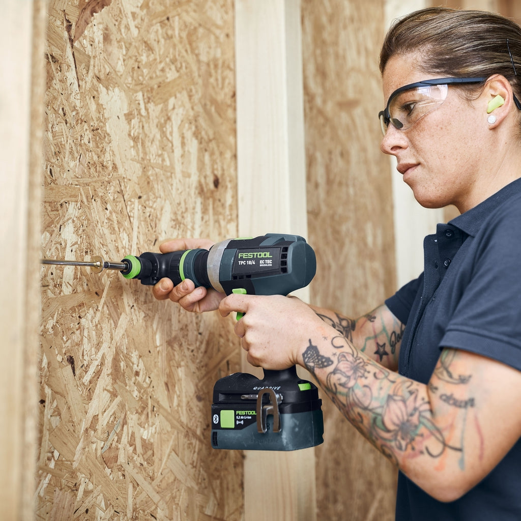 Carpenter uses Festool TPC with right angle attachment and Centrotec chuck to drive a long screw between wood studs.