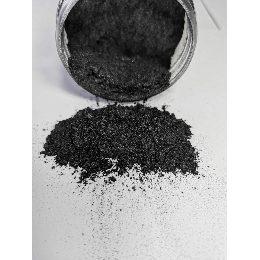 A jar of Black Grey Ryver Epoxy Aurora Metallic Pigment on its side showing the actual colour and consistency of mica.