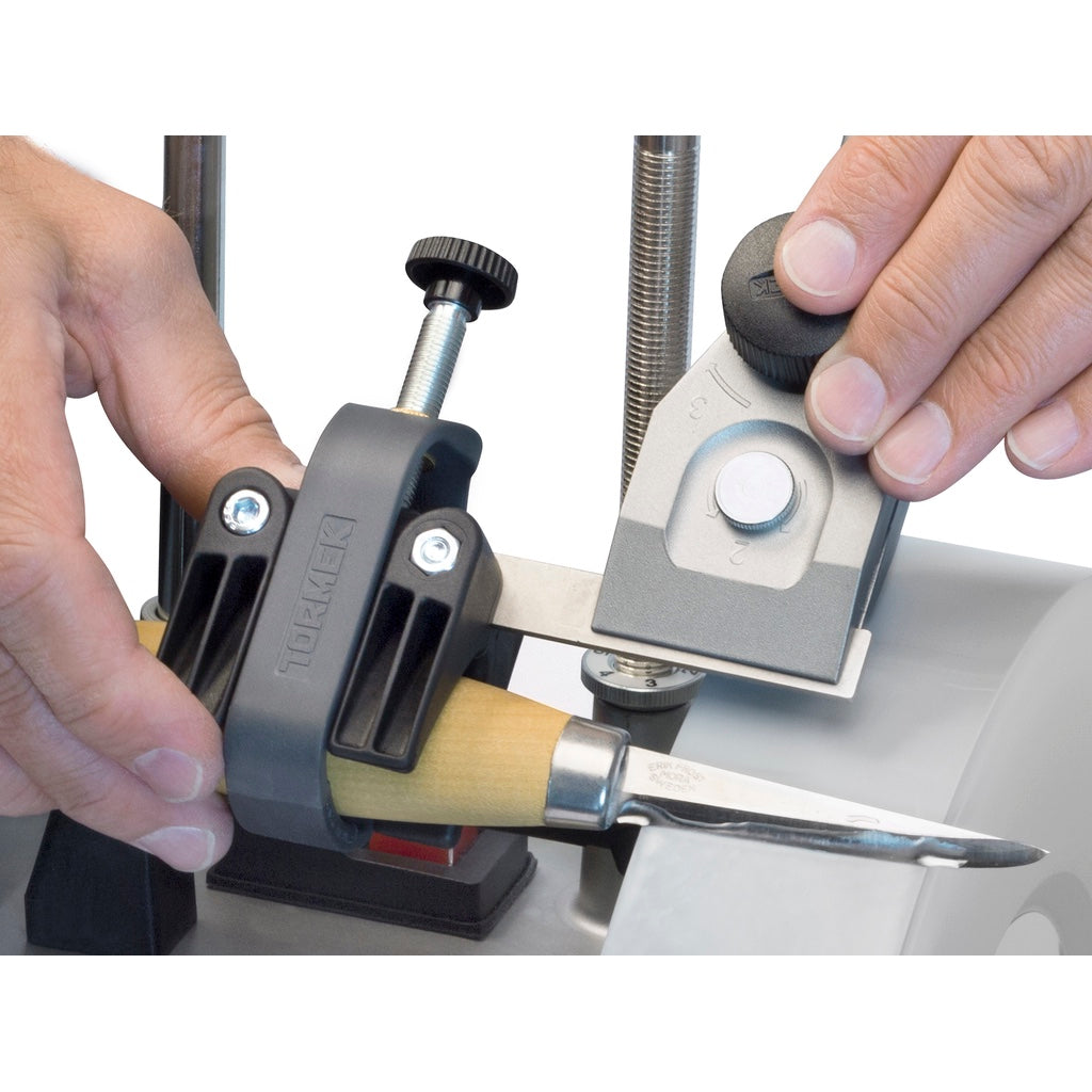 Tormek SVM-00 Small Knife Holder jig with SVM-45 Knife Jig sharpening a wood-handled knife with a short 2 inch blade.