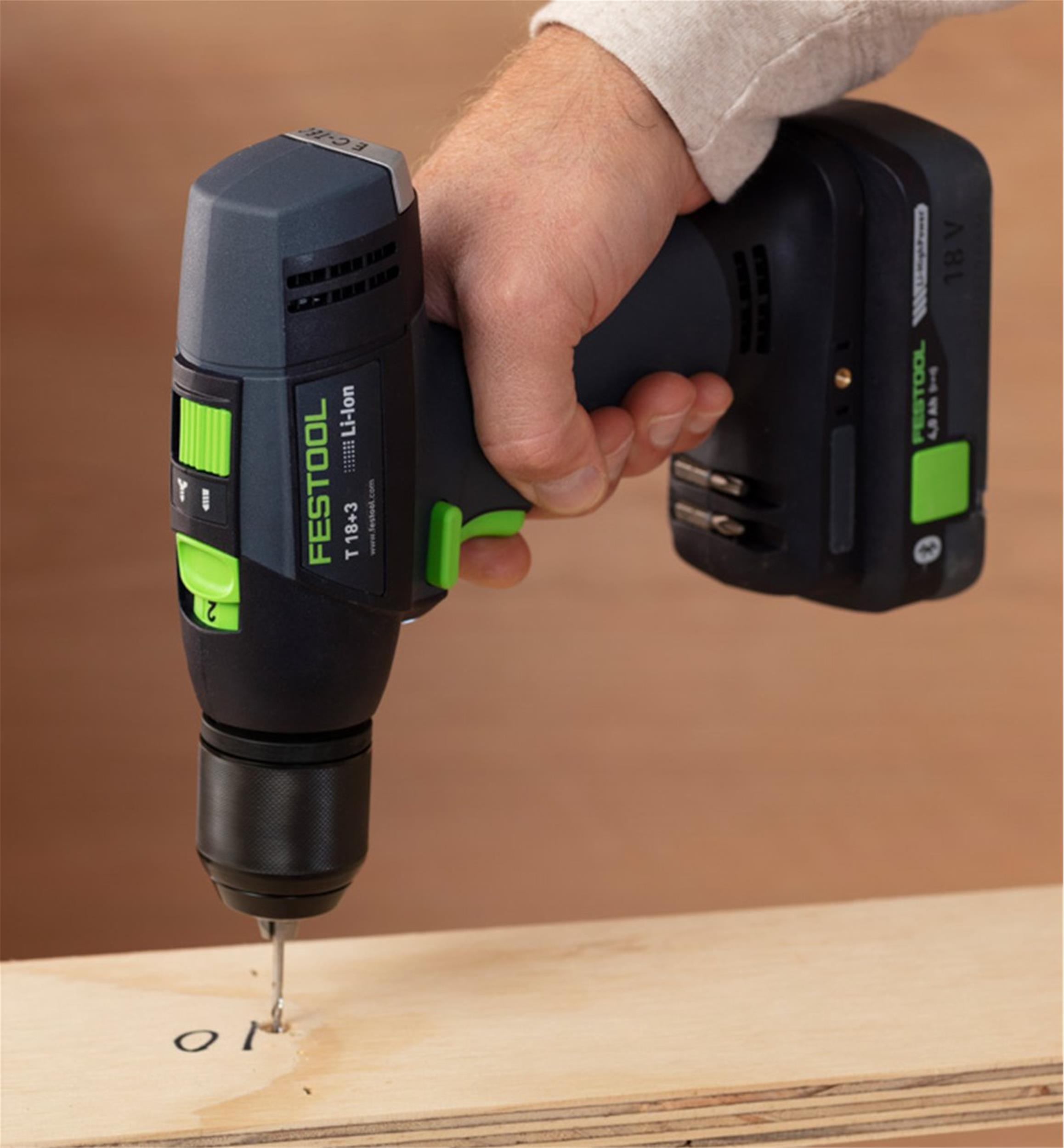 An operator used the Festool T 18 Easy set to speed 2 to drill a 1/8" hole in a piece of 3/4" thick plywood.